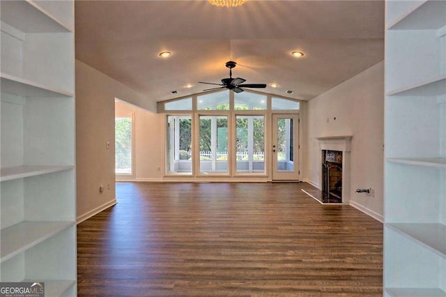 unfurnished living room with lofted ceiling, dark wood finished floors, baseboards, and a premium fireplace