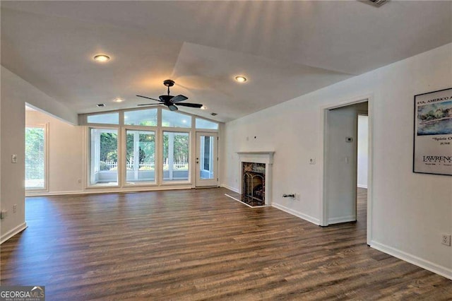 unfurnished living room with baseboards, vaulted ceiling, dark wood-type flooring, and a high end fireplace