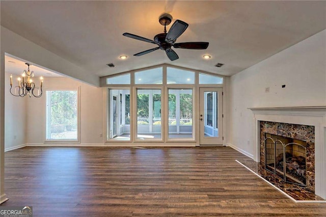 unfurnished living room with vaulted ceiling, dark wood-style flooring, a premium fireplace, and visible vents