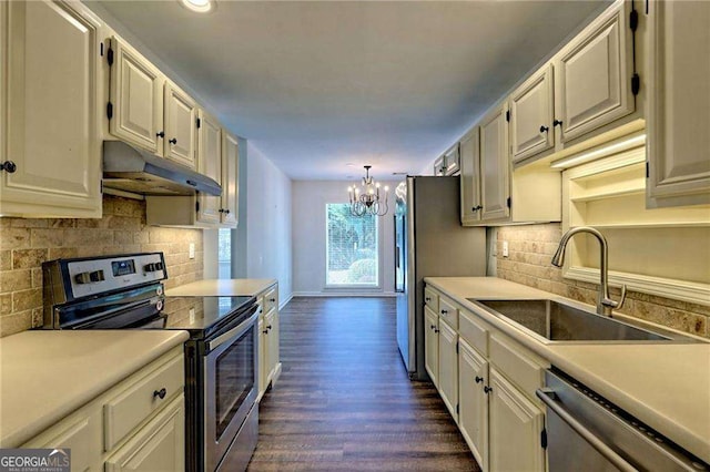 kitchen with under cabinet range hood, a sink, white cabinets, light countertops, and appliances with stainless steel finishes