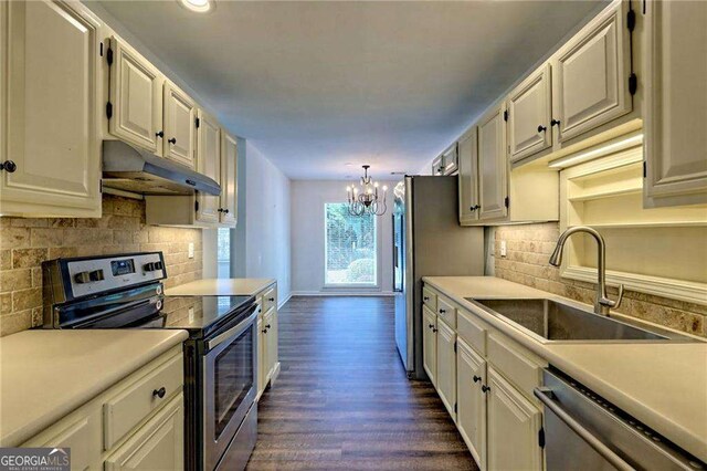 185 Starlight Dr, Sautee Nacoochee, GA 30571 - kitchen with a chandelier, under cabinet range hood, a sink, light countertops, and stainless steel appliances