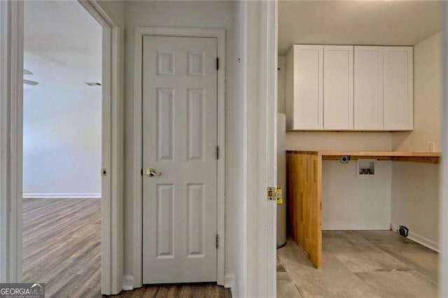 washroom with laundry area, hookup for a washing machine, and baseboards