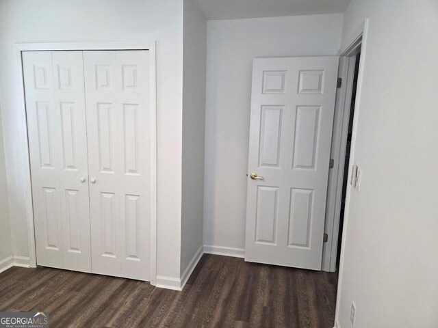 185 Starlight Dr, Sautee Nacoochee, GA 30571 - unfurnished bedroom featuring a closet, baseboards, and dark wood finished floors