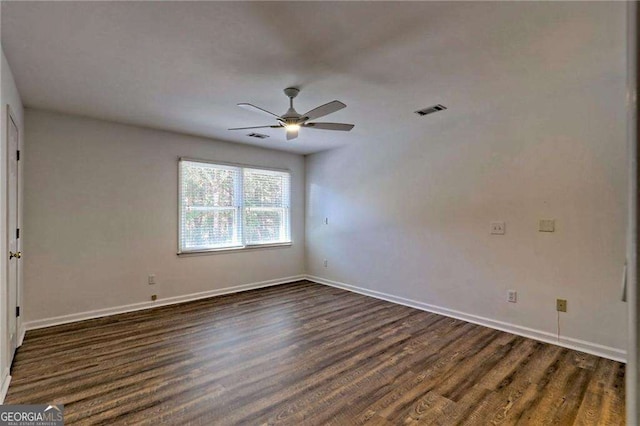 unfurnished bedroom featuring baseboards, visible vents, ceiling fan, and dark wood-type flooring