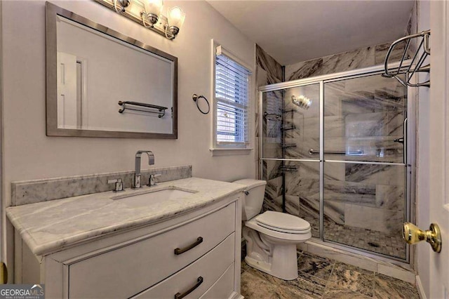 bathroom featuring toilet, a stall shower, and vanity