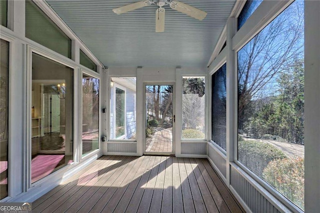 unfurnished sunroom with ceiling fan