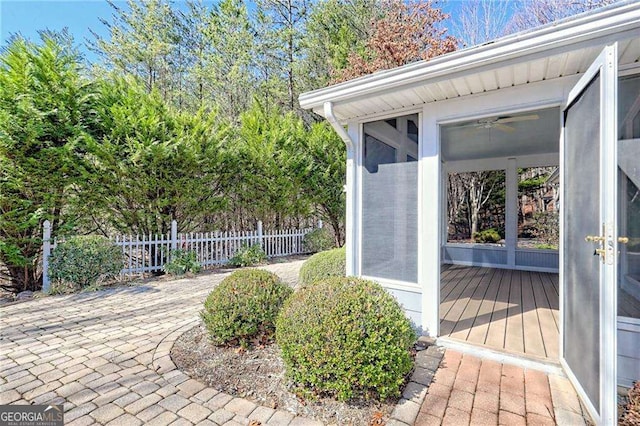 entrance to property featuring fence