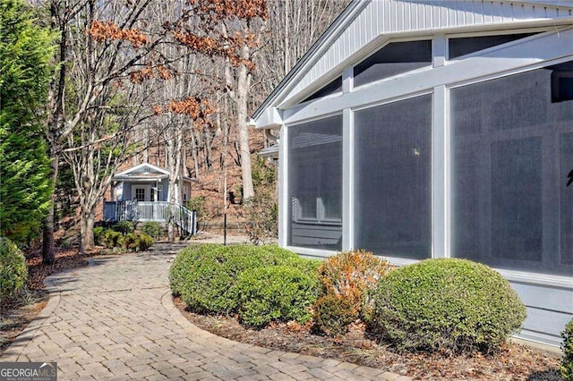 view of side of home featuring a sunroom