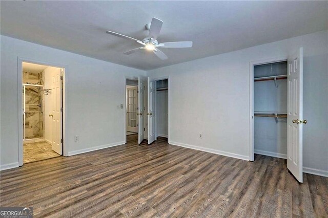 185 Starlight Dr, Sautee Nacoochee, GA 30571 - unfurnished bedroom featuring multiple closets, wood finished floors, and baseboards