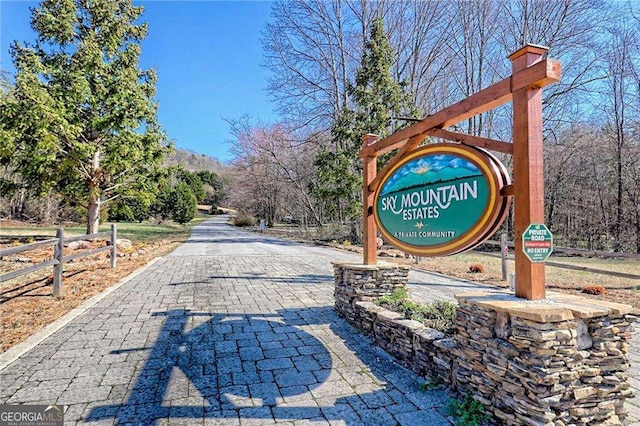 view of community with decorative driveway