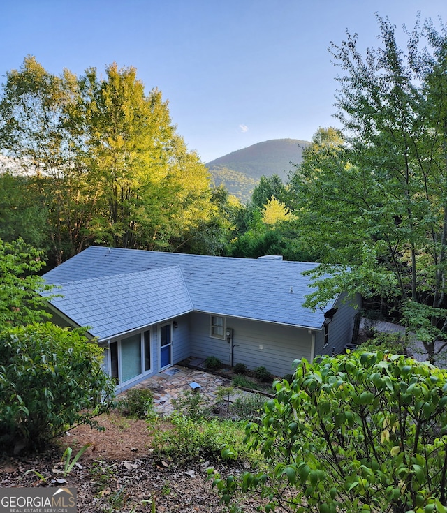 view of front of home with a patio area and a mountain view