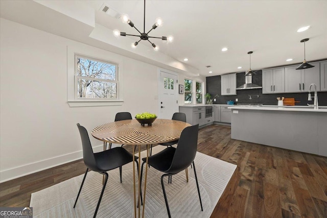 dining area featuring a healthy amount of sunlight, baseboards, dark wood finished floors, and recessed lighting