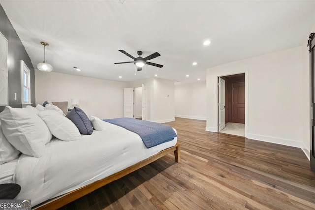 bedroom with baseboards, ceiling fan, wood finished floors, and recessed lighting