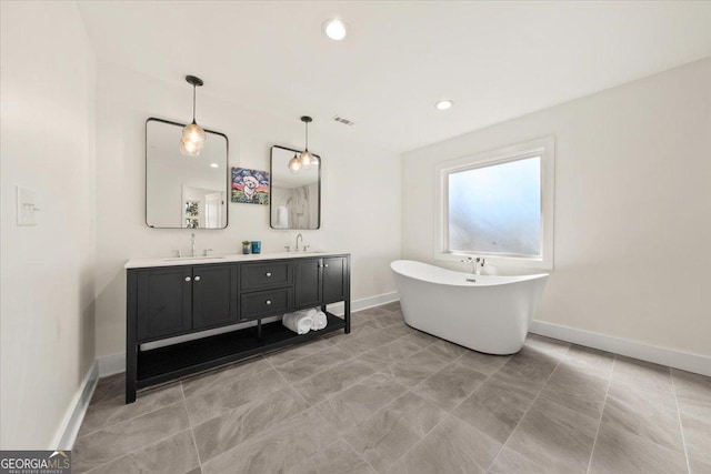 full bathroom with double vanity, baseboards, visible vents, and a sink