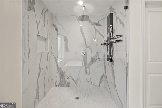 details featuring a marble finish shower