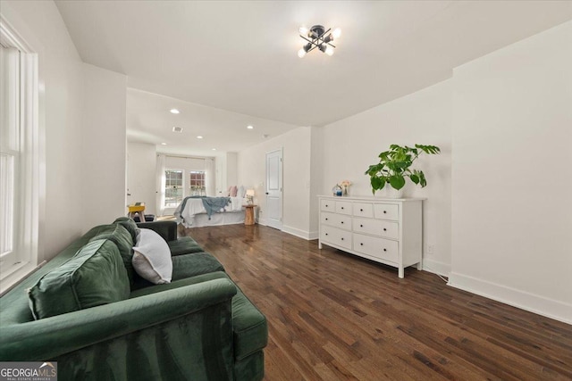 living area with recessed lighting, wood finished floors, and baseboards