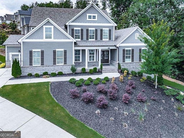 view of front of home with a front lawn and a shingled roof