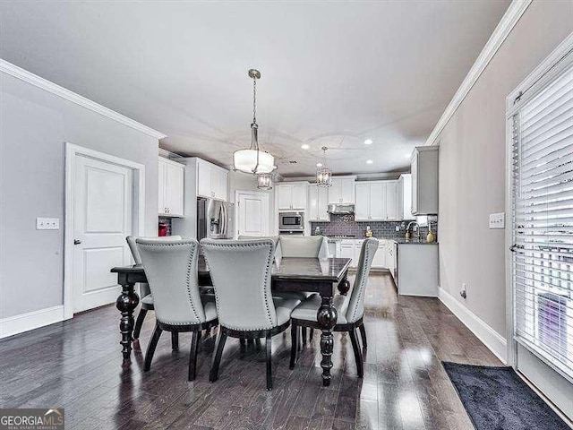 dining area featuring baseboards, ornamental molding, dark wood finished floors, and recessed lighting