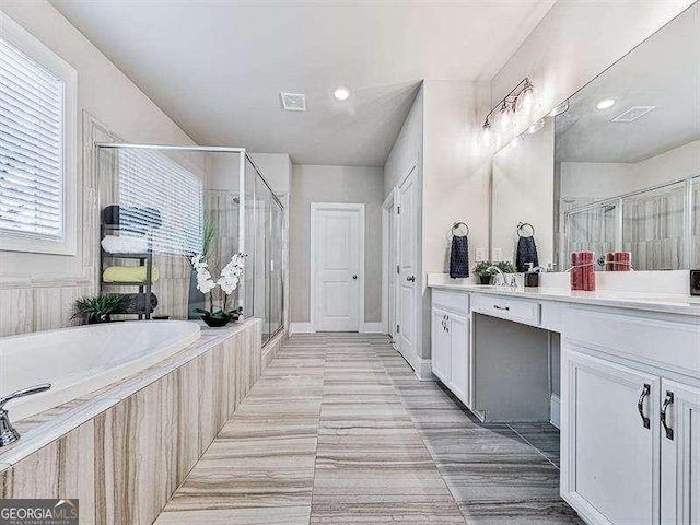 full bathroom with a garden tub, a shower stall, visible vents, and vanity