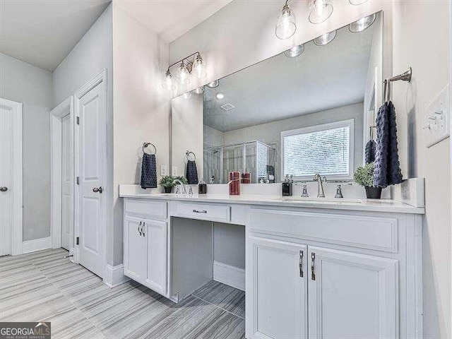 bathroom featuring double vanity, a sink, and a shower stall