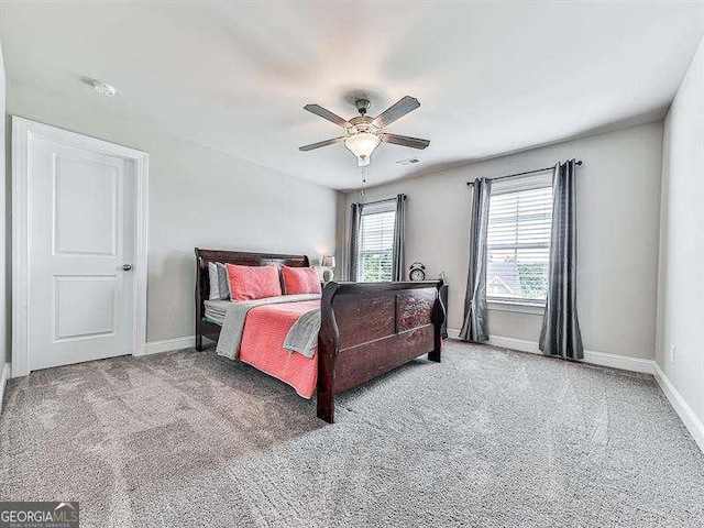 carpeted bedroom featuring visible vents, a ceiling fan, and baseboards