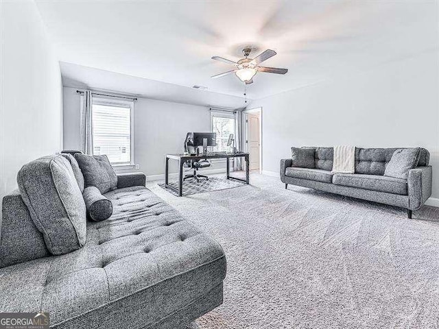 living area with visible vents, carpet floors, a ceiling fan, and baseboards