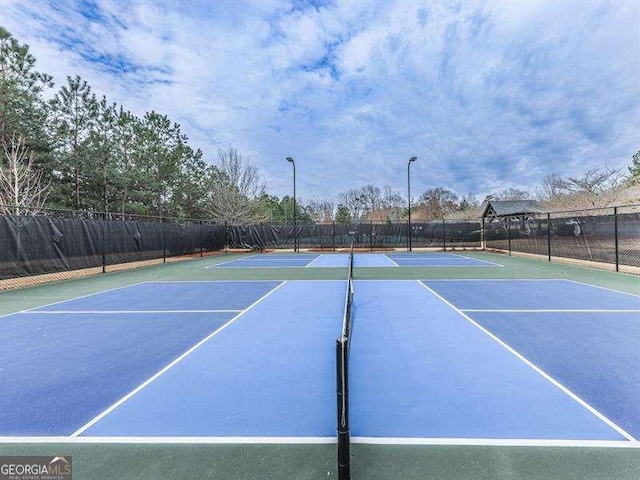 view of sport court with fence