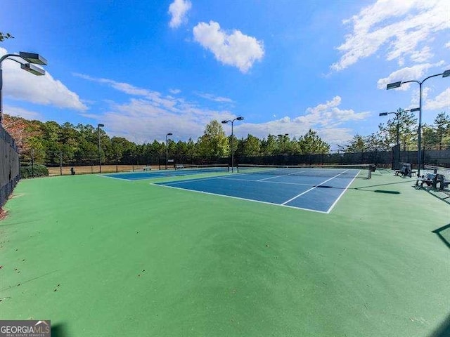 view of sport court with fence