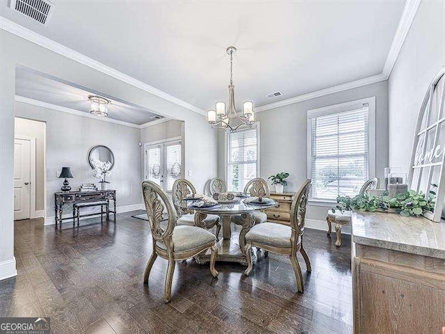 dining area featuring a chandelier, dark wood finished floors, and visible vents