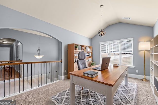 office space featuring lofted ceiling, visible vents, light carpet, and baseboards