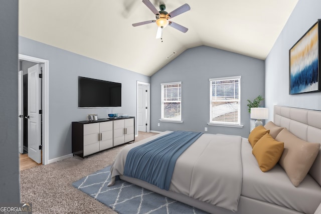 carpeted bedroom with lofted ceiling, baseboards, visible vents, and ceiling fan