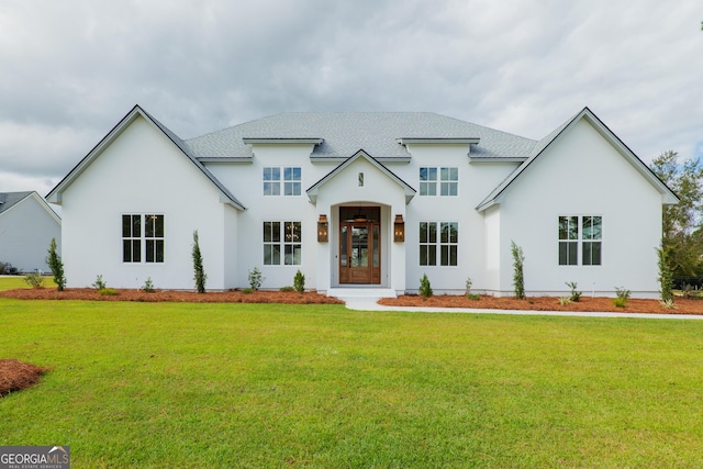 view of front of house featuring a front lawn and stucco siding