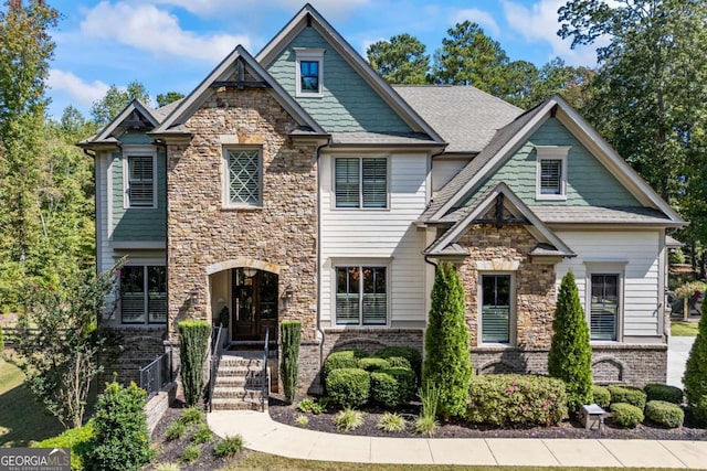 craftsman house featuring brick siding