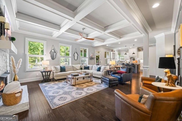 living room featuring coffered ceiling, a fireplace, ornamental molding, beam ceiling, and dark wood-style floors