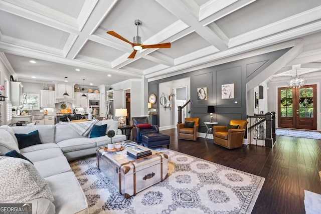 living area featuring arched walkways, dark wood finished floors, coffered ceiling, crown molding, and beam ceiling