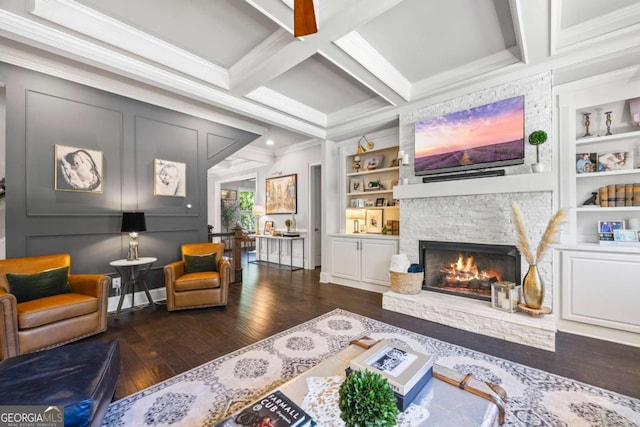 sitting room featuring dark wood finished floors, built in features, coffered ceiling, and beamed ceiling