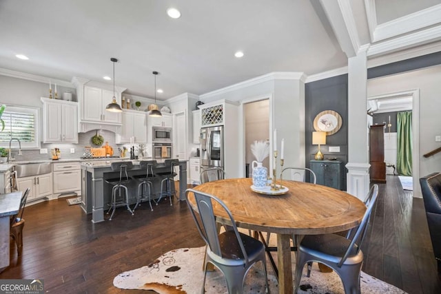 dining space featuring dark wood-type flooring, recessed lighting, and crown molding