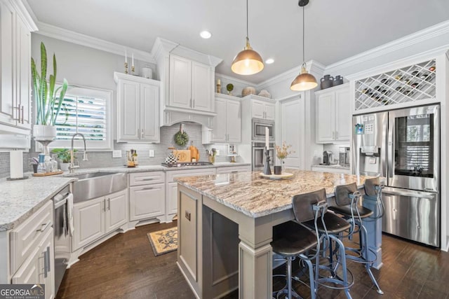 kitchen featuring stainless steel appliances, a kitchen island, and white cabinets