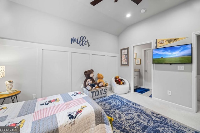 carpeted bedroom featuring lofted ceiling, ceiling fan, recessed lighting, a decorative wall, and wainscoting