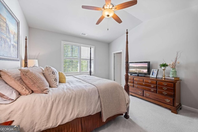 bedroom featuring lofted ceiling, light carpet, visible vents, baseboards, and a ceiling fan