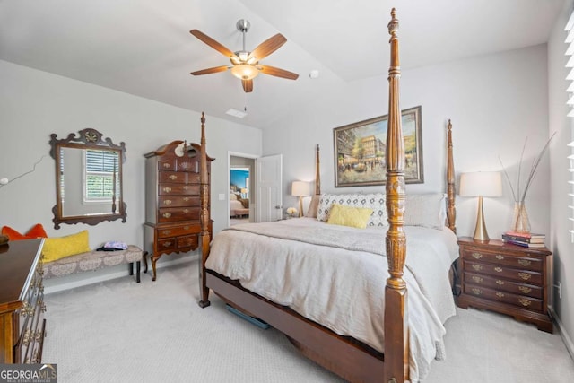 bedroom featuring light carpet, vaulted ceiling, and ceiling fan