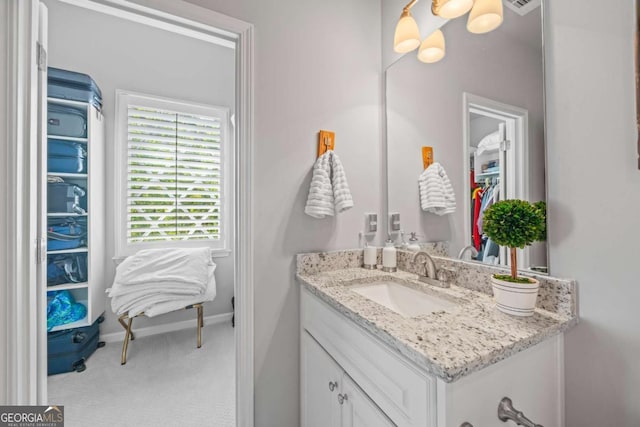 bathroom with vanity and baseboards