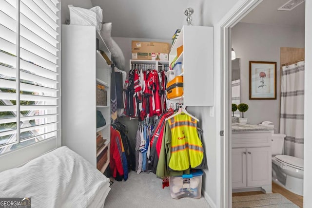 spacious closet featuring light carpet and visible vents