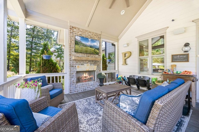 sunroom / solarium featuring lofted ceiling and an outdoor brick fireplace