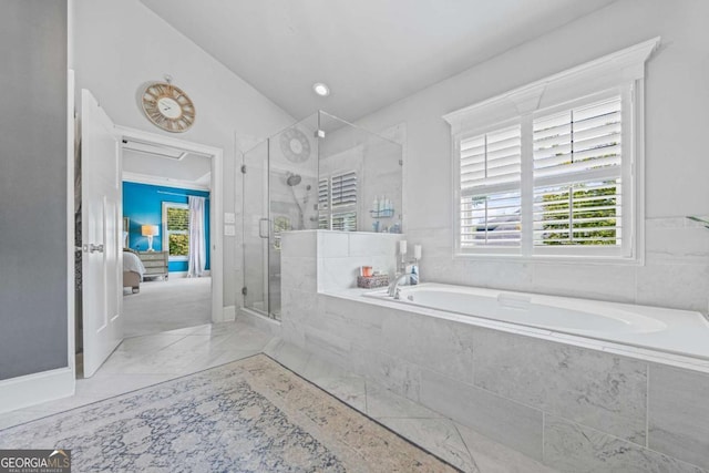 ensuite bathroom with a stall shower, marble finish floor, a garden tub, and ensuite bath