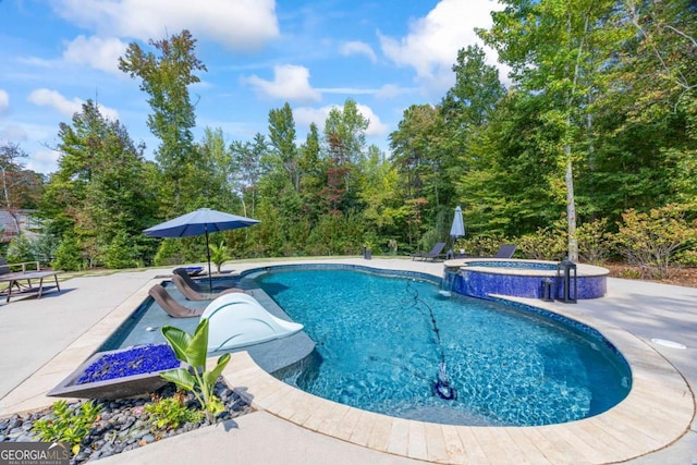 view of pool featuring a patio area and a pool with connected hot tub