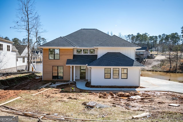 view of front facade featuring a shingled roof and board and batten siding