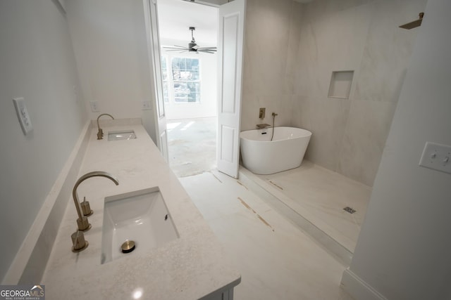 bathroom featuring double vanity, a freestanding bath, and a sink