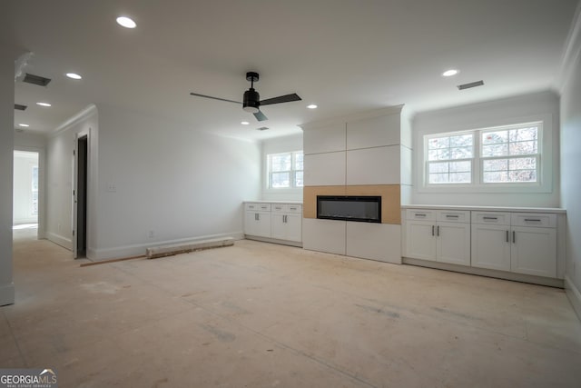 unfurnished living room featuring recessed lighting, visible vents, crown molding, and baseboards