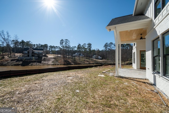 view of yard featuring ceiling fan and a patio area